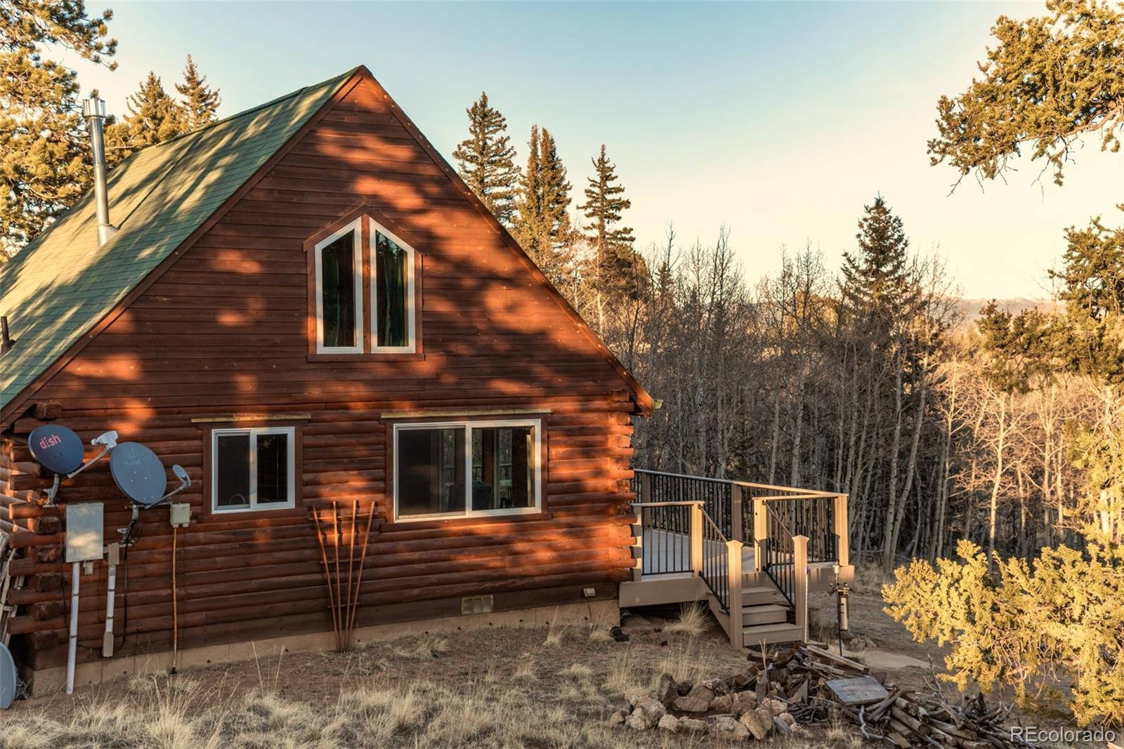 753 Teton Trail Como, CO 80456 - Photo 25 of 32 a backyard of a house with wooden fence and large trees
