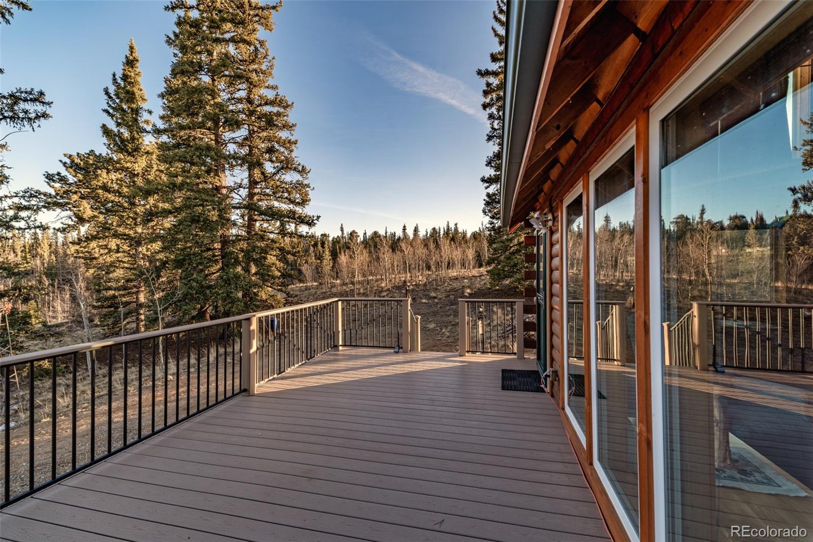 753 Teton Trail Como, CO 80456 - Photo 28 of 32 a view of a balcony with wooden floor and iron stairs