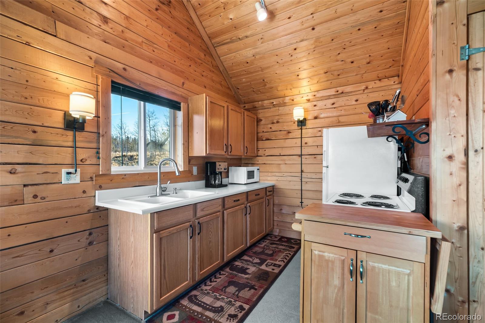 753 Teton Trail Como, CO 80456 - Photo 3 of 32 a kitchen with a sink stove and cabinets