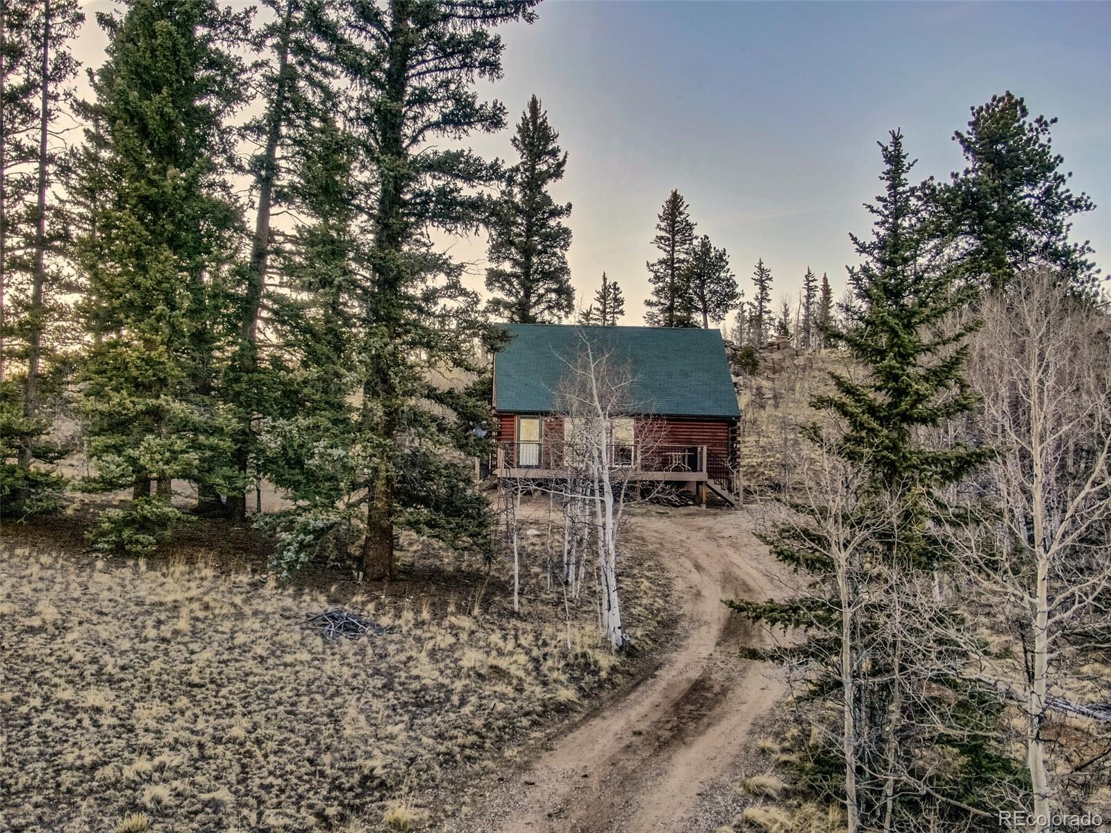 753 Teton Trail Como, CO 80456 - Photo 31 of 32 a backyard of a house with table and chairs