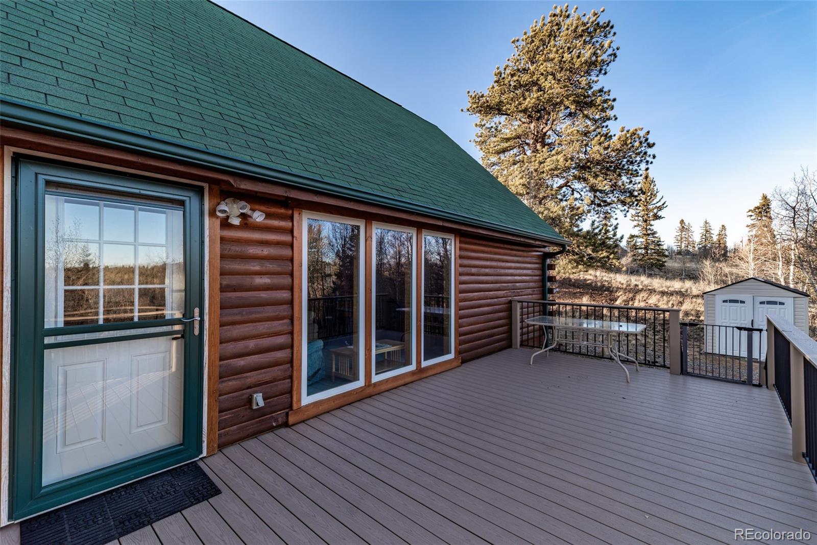 753 Teton Trail Como, CO 80456 - Photo 5 of 32 a view of a house with a large window and wooden floor