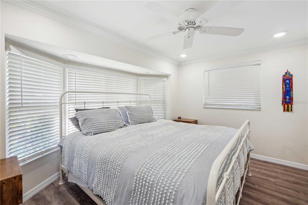 5307 Flint Street Zephyrhills, FL 33542 - Photo 16 of 63 a bedroom with a bed and a chandelier