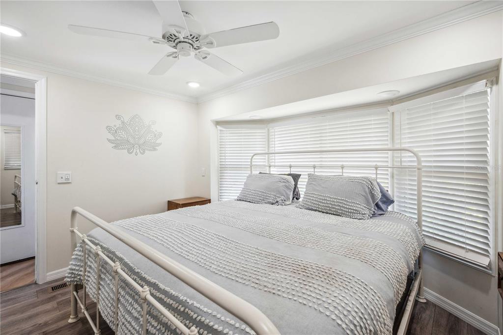 5307 Flint Street Zephyrhills, FL 33542 - Photo 17 of 63 a bedroom with a white bed and a chandelier