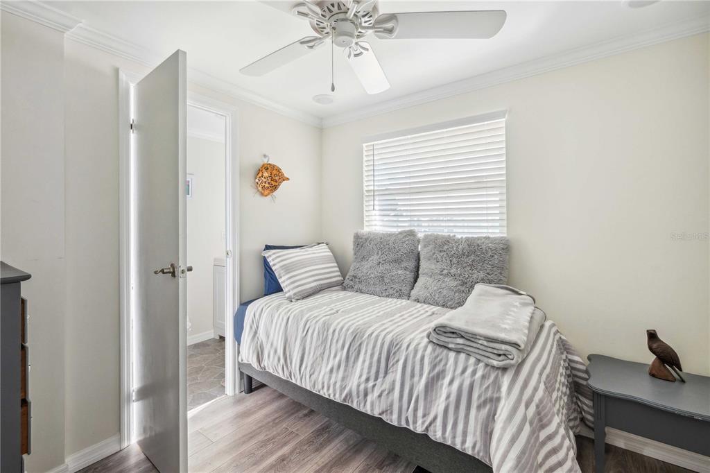 5307 Flint Street Zephyrhills, FL 33542 - Photo 19 of 63 a bedroom with a bed and a chandelier