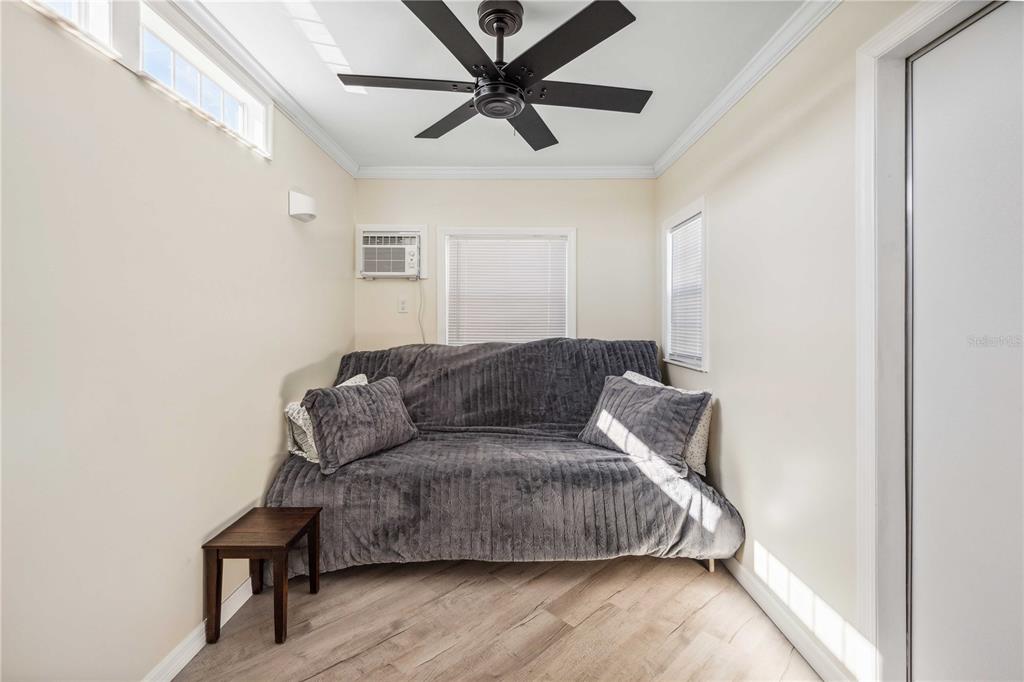 5307 Flint Street Zephyrhills, FL 33542 - Photo 25 of 63 a living room with a couch and a ceiling fan