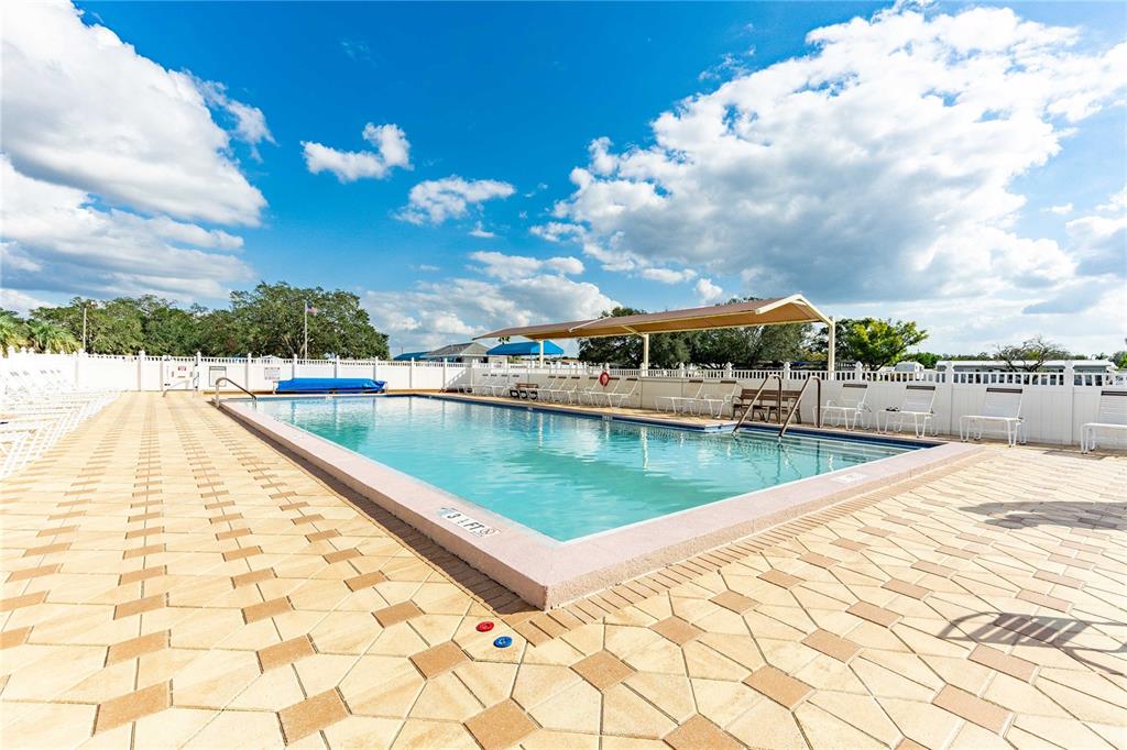 5307 Flint Street Zephyrhills, FL 33542 - Photo 30 of 63 a view of swimming pool with outdoor seating