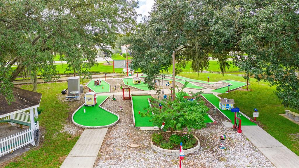 5307 Flint Street Zephyrhills, FL 33542 - Photo 35 of 63 an aerial view of a house with swimming pool and yard
