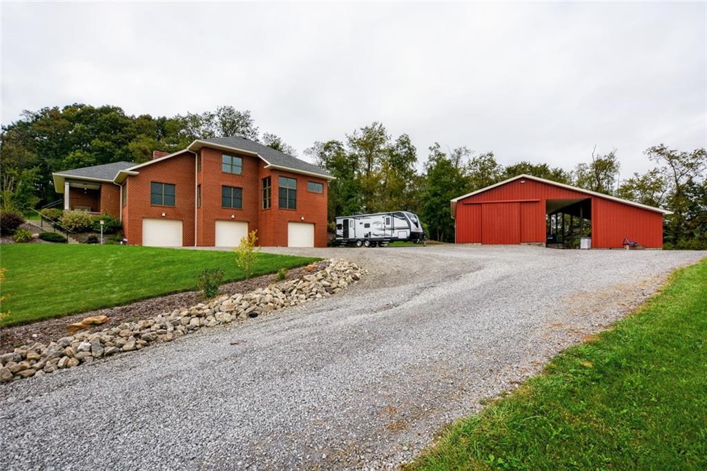 231 Anderson Road Butler, PA 16002 - Photo 22 of 25 Oversized 3 car integral garage with 10x8 garage door and a 50x42 pole building with 40x24 enclosed with a concrete floor