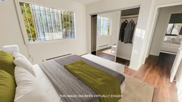 a bed sitting in a bedroom next to a window