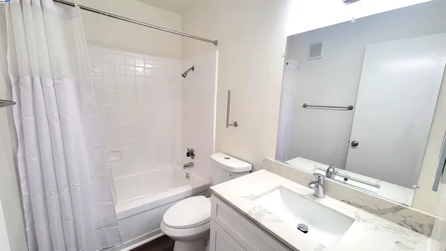 a bathroom with a sink mirror toilet and bathtub