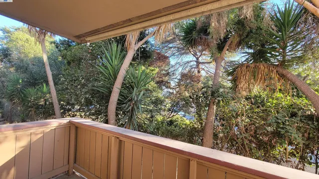 a balcony with trees in front of it