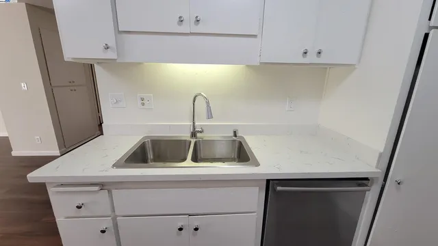 a kitchen with a sink and cabinets