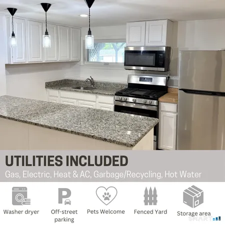 a kitchen with kitchen island granite countertop a stove top oven a sink a counter top space and cabinets