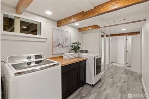 a utility room with sink dryer and washer