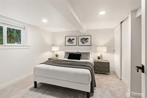 a bedroom with a bed and a night stand