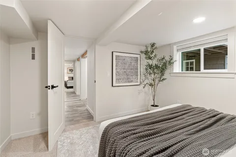 a bedroom with a bed and a large mirror