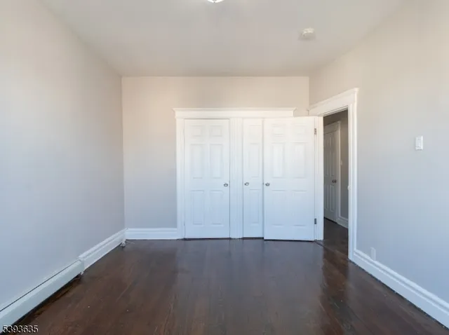 an empty room with wooden floor