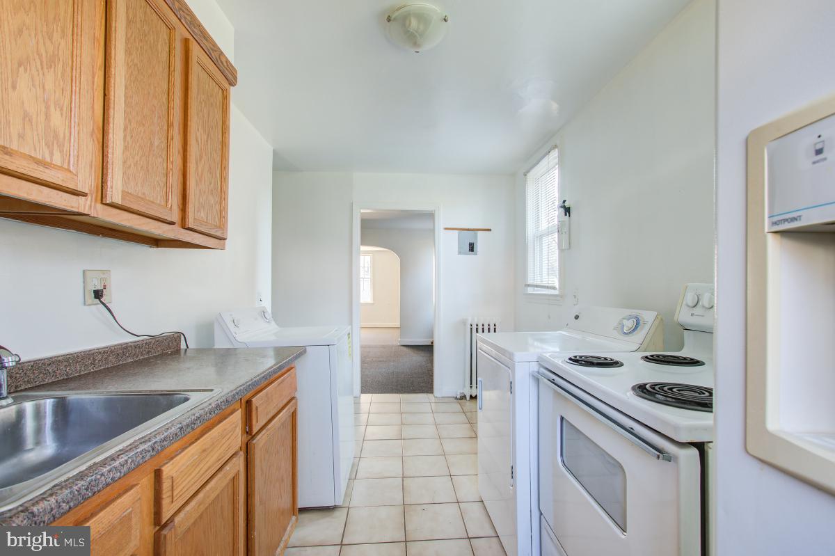 6120 41st Avenue, Unit 1 Hyattsville, MD 20782 - Photo 13 of 28 a kitchen with a sink cabinets and appliances
