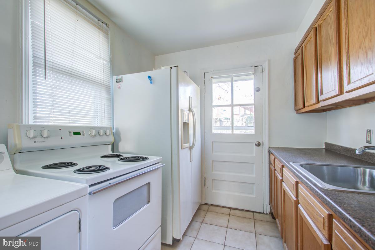 6120 41st Avenue, Unit 1 Hyattsville, MD 20782 - Photo 16 of 28 a kitchen with a stove cabinets and a refrigerator