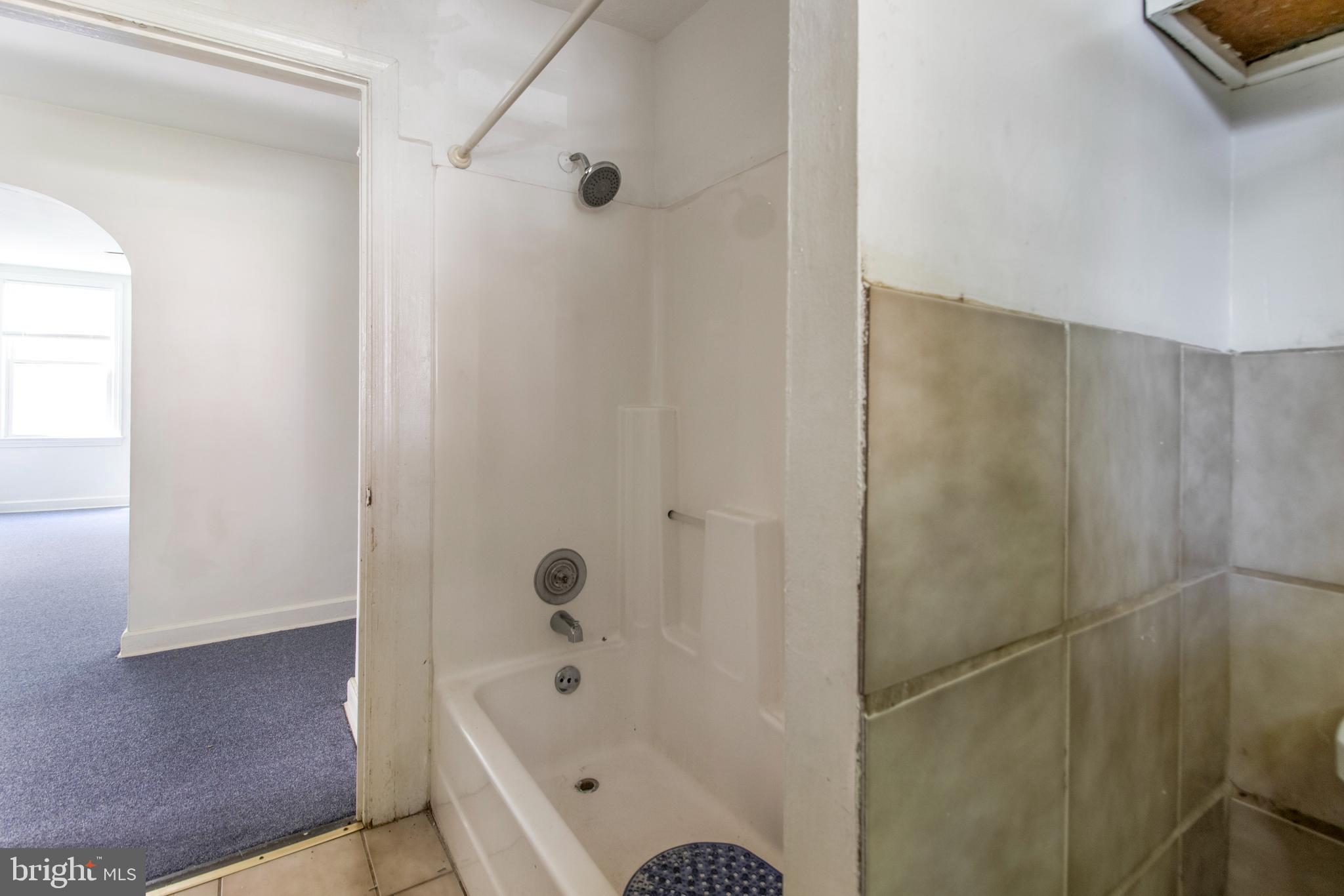 6120 41st Avenue, Unit 1 Hyattsville, MD 20782 - Photo 17 of 28 a bathroom with a tub shower and sink