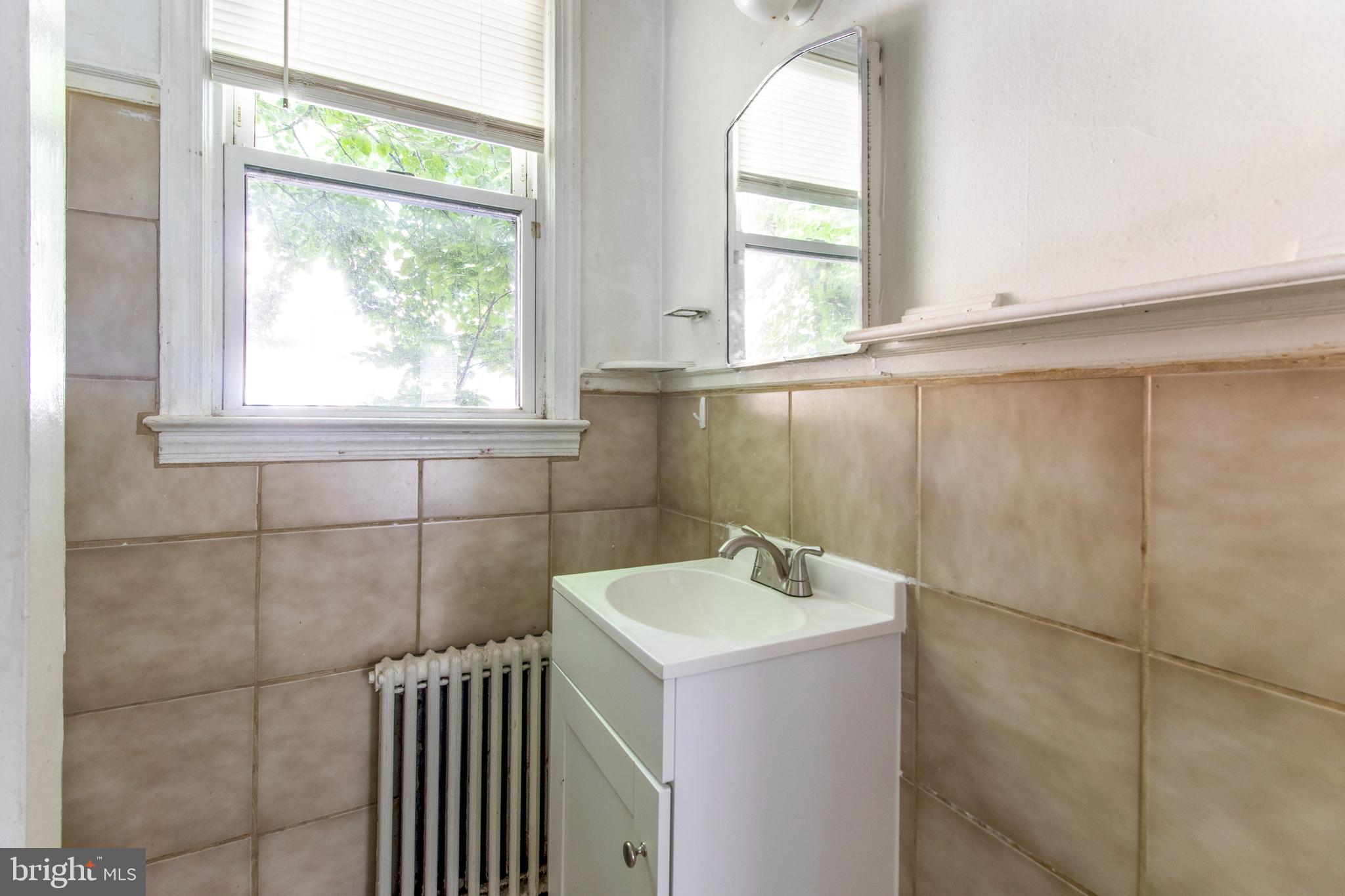 6120 41st Avenue, Unit 1 Hyattsville, MD 20782 - Photo 19 of 28 a bathroom with a sink and window