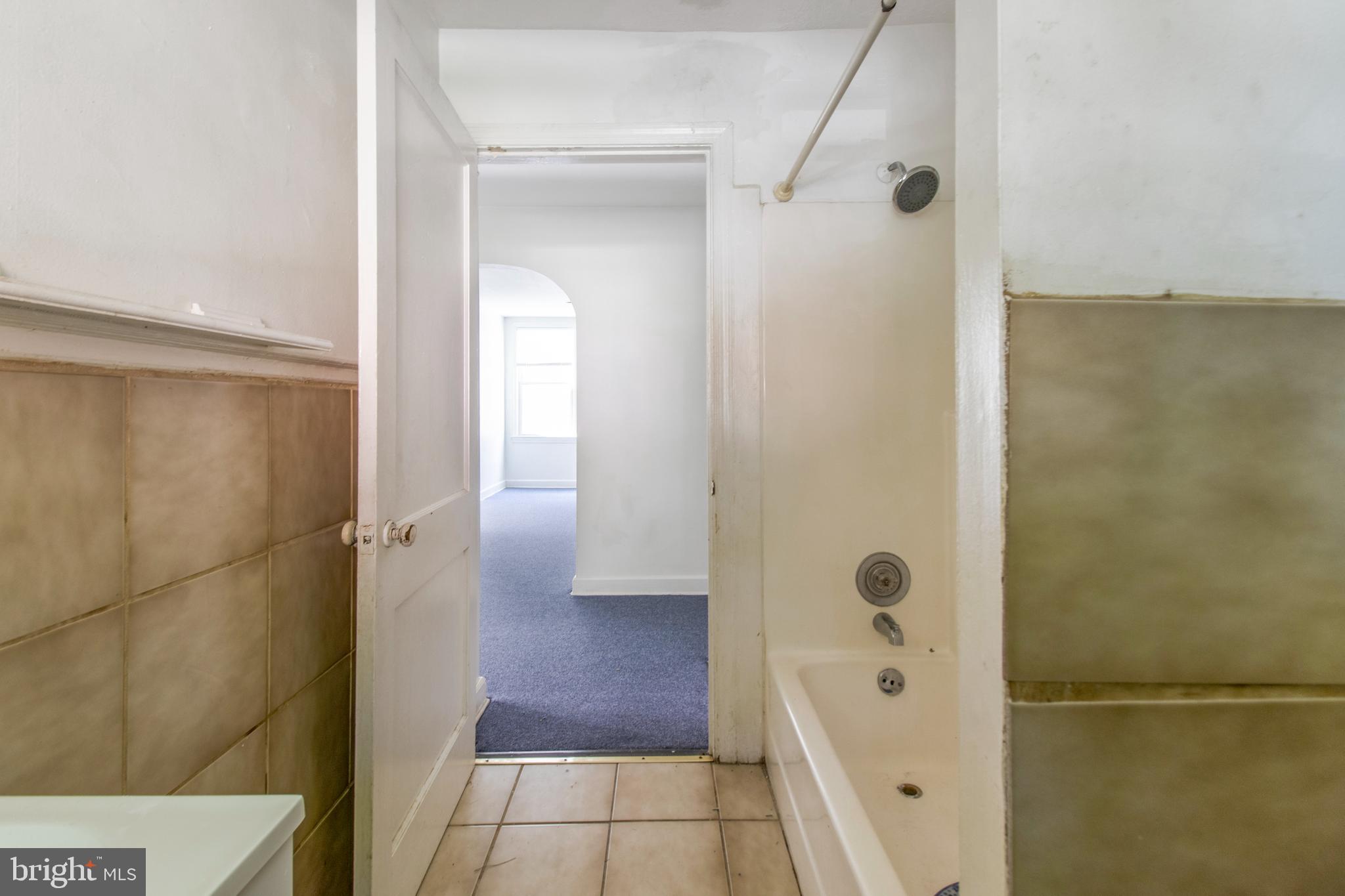 6120 41st Avenue, Unit 1 Hyattsville, MD 20782 - Photo 20 of 28 a bathroom with a glass shower door