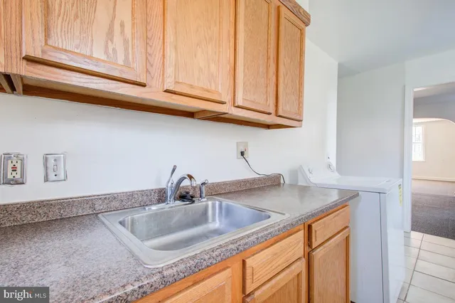 a kitchen with stainless steel appliances granite countertop a sink a stove and cabinets