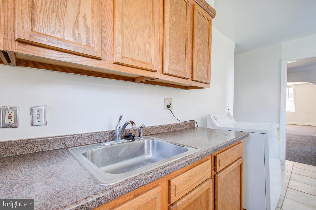 6120 41st Avenue, Unit 1 Hyattsville, MD 20782 - Photo 8 of 28 a kitchen with stainless steel appliances granite countertop a sink a stove and cabinets