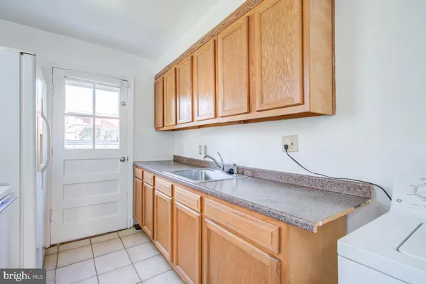 a kitchen with a sink cabinets and utility