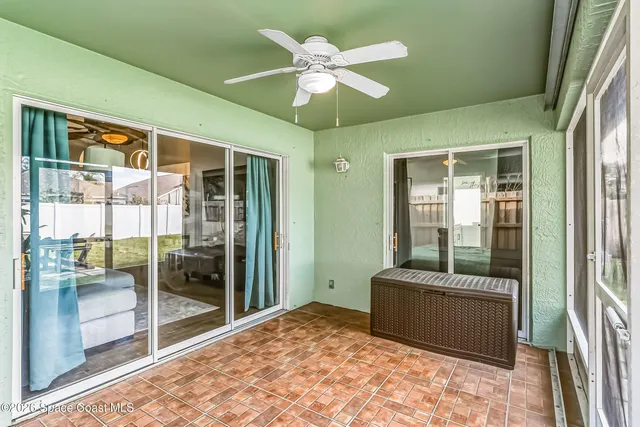 a living room with a bed and a chandelier