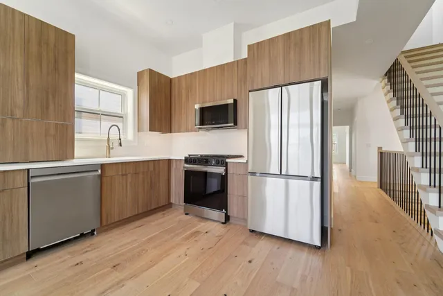a kitchen with a refrigerator and a sink