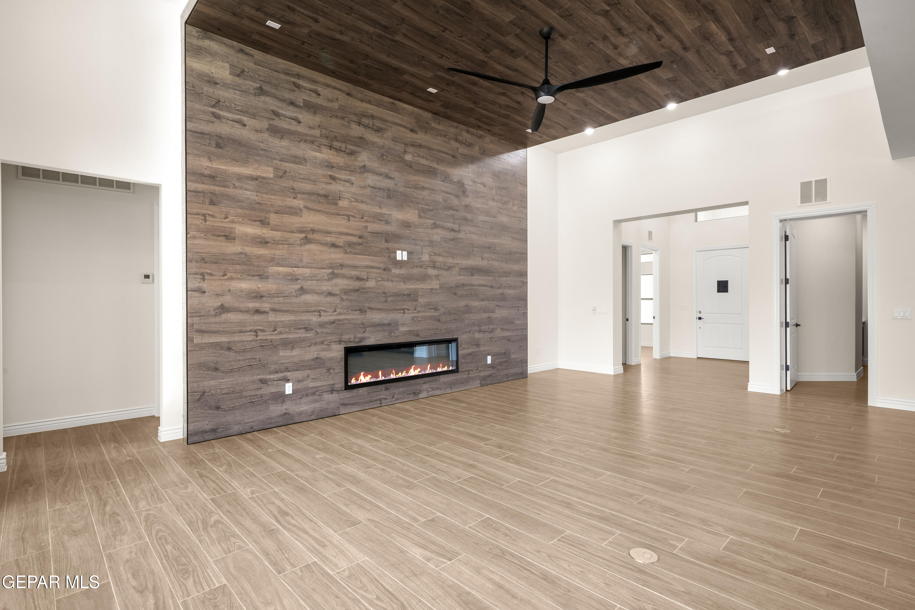 5646 River Run Street El Paso, TX 79932 - Photo 10 of 66 a view of an empty room with wooden floor and a fireplace