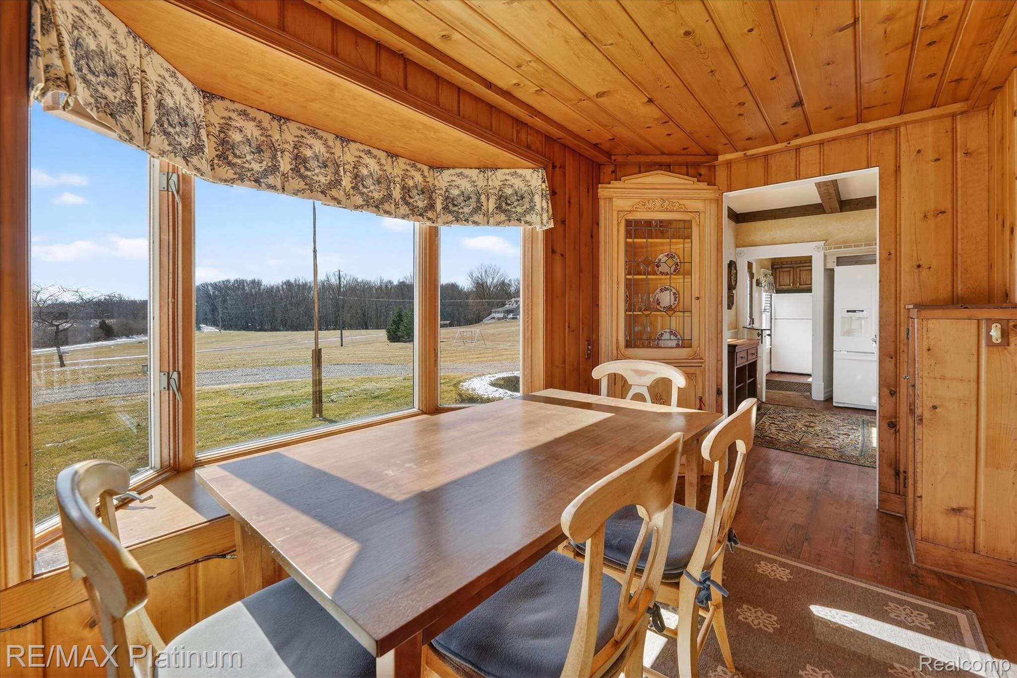 15330 Howlett Road Gregory, MI 48137 - Photo 7 of 26 Dining area with dark wood-type flooring, wooden walls, and wood ceiling