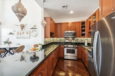 a bedroom with a bed a mirror and a window