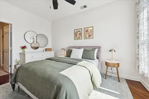 a bedroom with a bed and a large window