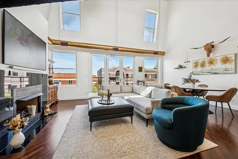 a view of a room with furniture and wooden floor