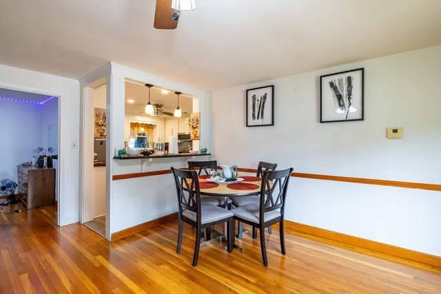 a dining room with furniture and wooden floor
