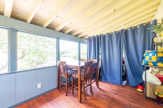 a view of a dining room with furniture and a window