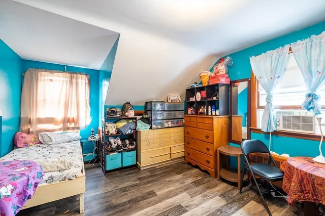 a bedroom with furniture and a wooden floor