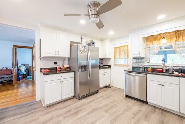 a kitchen with stainless steel appliances a refrigerator sink and cabinets