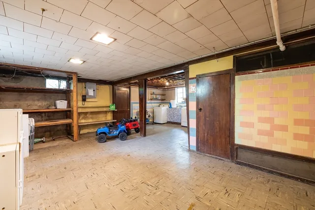 a view of a empty room with storage and a window