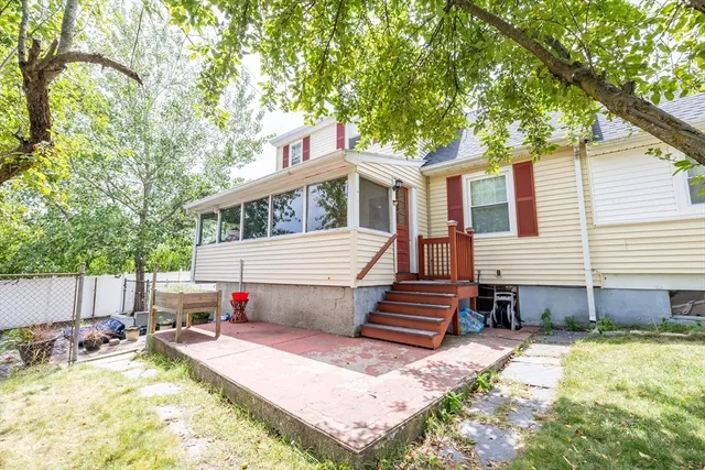 a view of a house with a yard and furniture