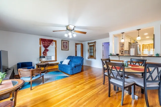 a living room with furniture a dining table and a piano table