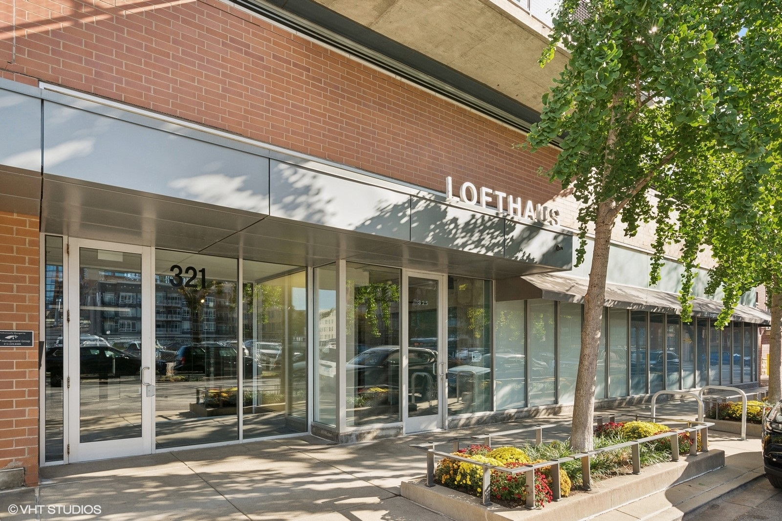 321 South Sangamon Street, Unit 502 Chicago, IL 60607 - Photo 1 of 19 a front view of a building with glass windows and palm trees