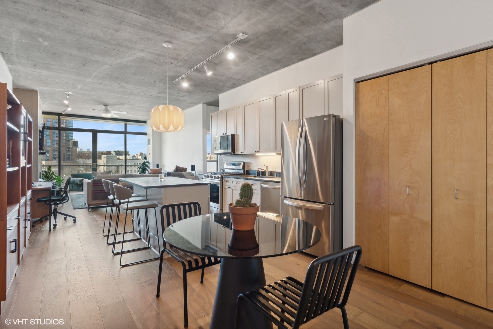 321 South Sangamon Street, Unit 502 Chicago, IL 60607 - Photo 11 of 19 a kitchen with stainless steel appliances granite countertop a dining table chairs and a refrigerator