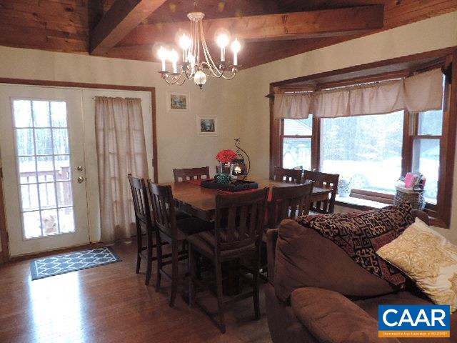 6451 Bell Road Dillwyn, VA 23936 - Photo 6 of 18 a view of a dining room with furniture a chandelier and wooden floor