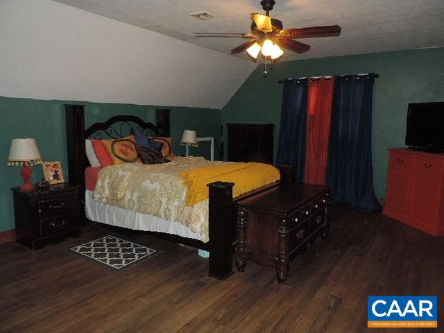6451 Bell Road Dillwyn, VA 23936 - Photo 8 of 18 a bedroom with a bed and wooden floor