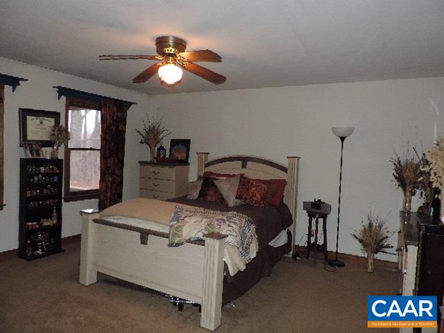 6451 Bell Road Dillwyn, VA 23936 - Photo 10 of 18 a bedroom with a bed and a chandelier