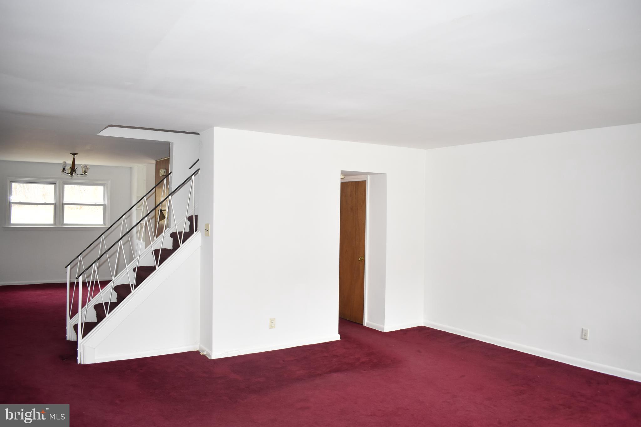 2723 East Country Club Road Philadelphia, PA 19131 - Photo 5 of 24 Living room with center staircase