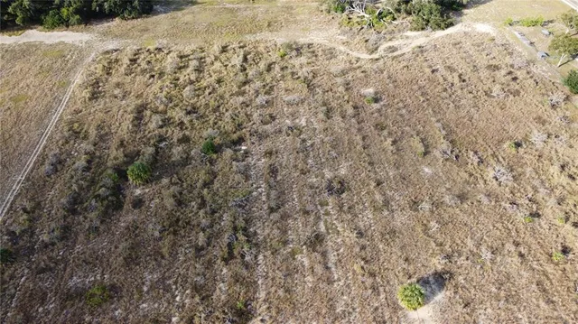 an aerial view of a house with a lake view